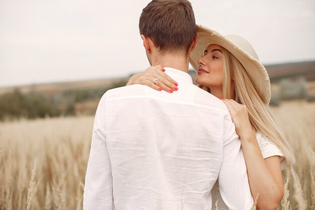 Beautiful couple spend time in a autumn field