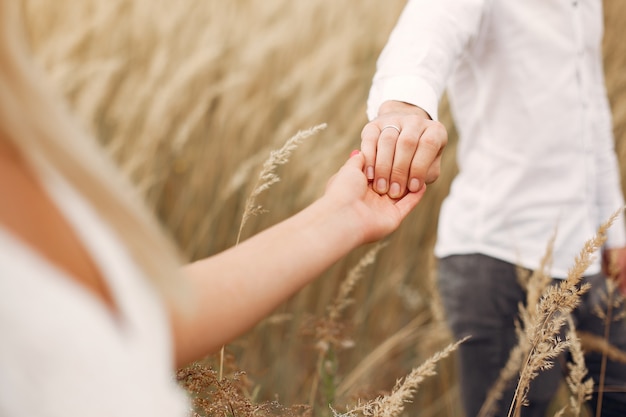 Beautiful couple spend time in a autumn field