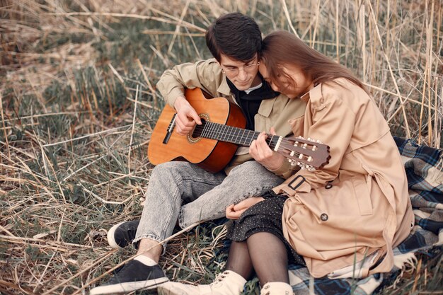 Beautiful couple spend time in an autumn field