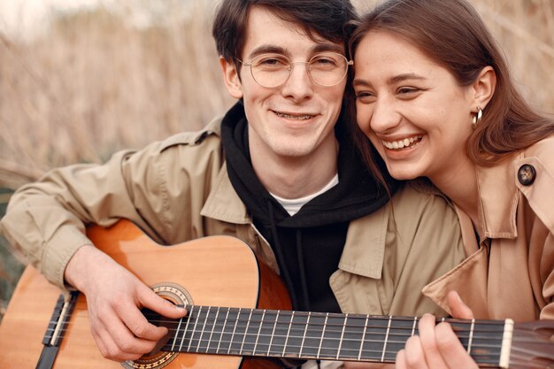 Beautiful couple spend time in an autumn field