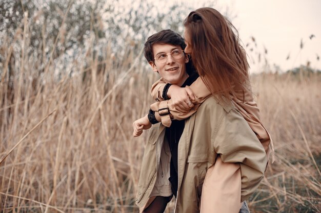 Beautiful couple spend time in an autumn field