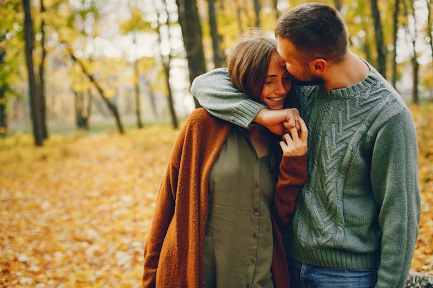 Beautiful couple spend time in a autumn park