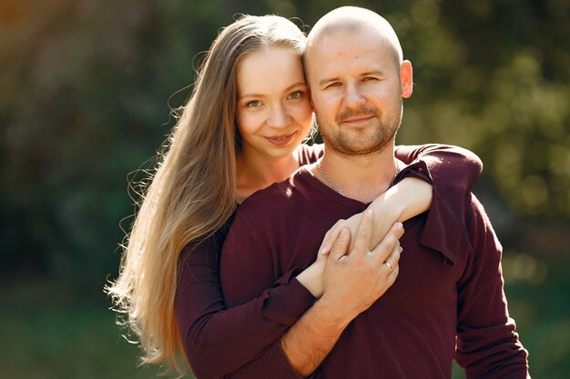 Beautiful couple spend time in a autumn park