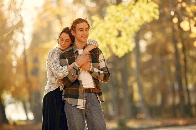 Beautiful couple spend time in a autumn park