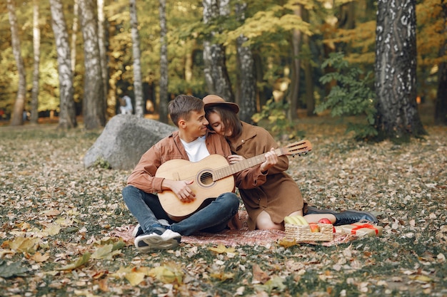 Free photo beautiful couple spend time in a autumn park