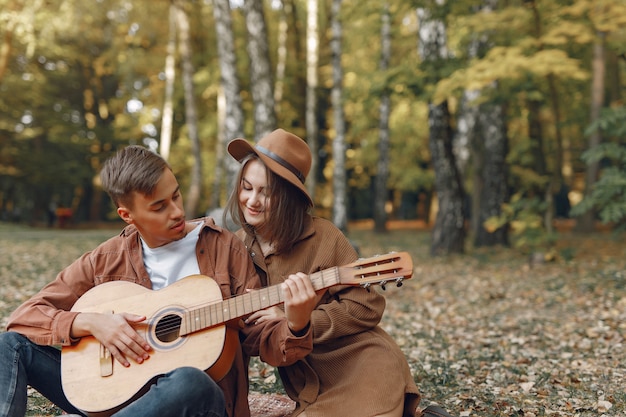 Beautiful couple spend time in a autumn park