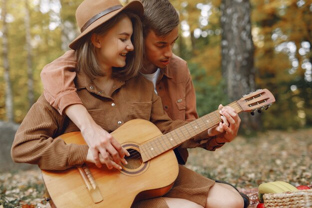 Beautiful couple spend time in a autumn park