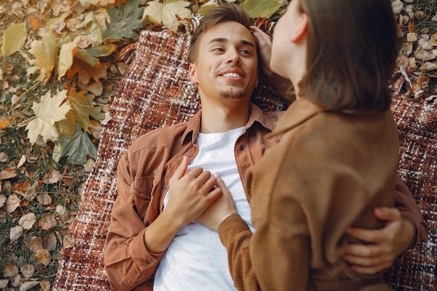 Beautiful couple spend time in a autumn park