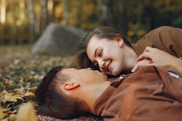 Beautiful couple spend time in a autumn park