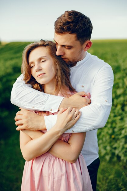 Beautiful couple spend time on a summer field