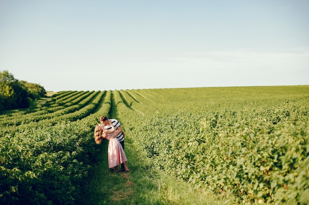 Free photo beautiful couple spend time on a summer field