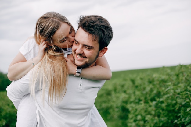 Free photo beautiful couple spend time on a summer field