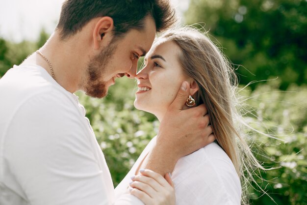 Beautiful couple spend time on a summer field