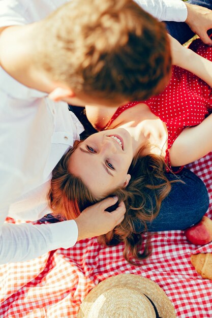 Beautiful couple spend time on a summer field