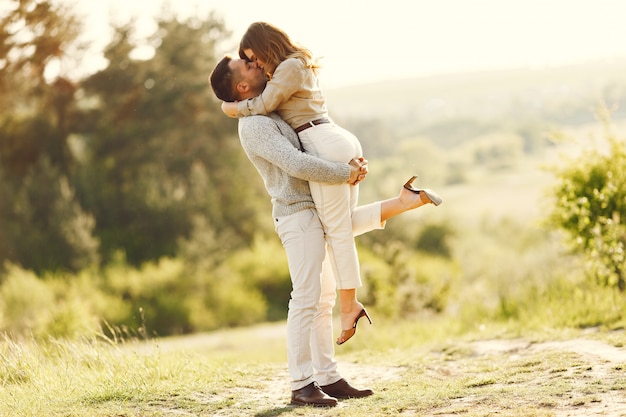 Beautiful couple spend time on a summer field