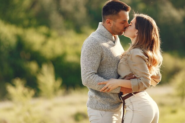 Beautiful couple spend time on a summer field