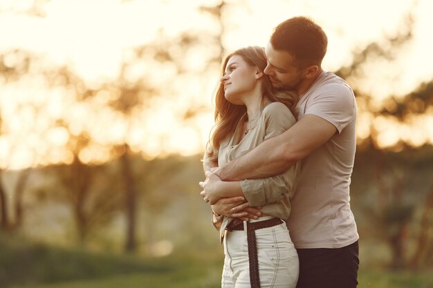 Beautiful couple spend time on a summer field