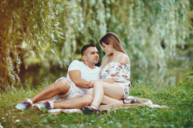 Beautiful couple spend time on a summer field