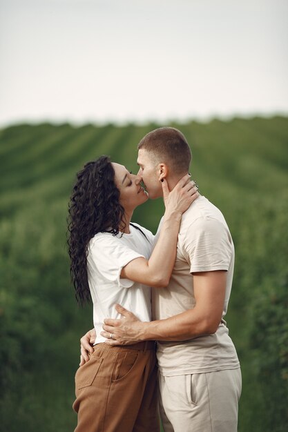 Beautiful couple spend time on a summer field