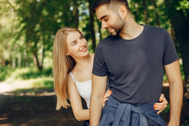 Beautiful couple spend time on a summer forest