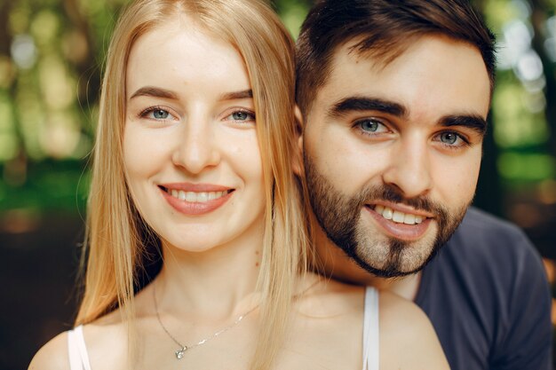 Beautiful couple spend time on a summer forest