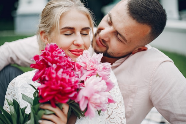 Free photo beautiful couple spend time in a summer garden