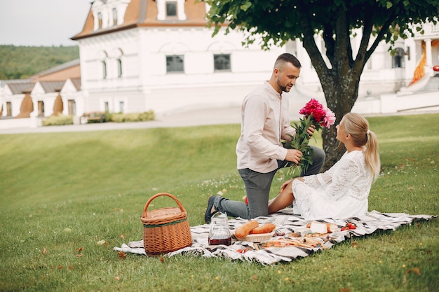 Beautiful couple spend time in a summer garden