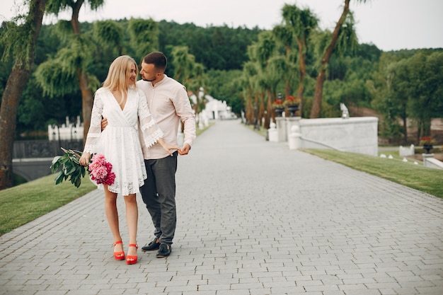 Free Photo beautiful couple spend time in a summer garden