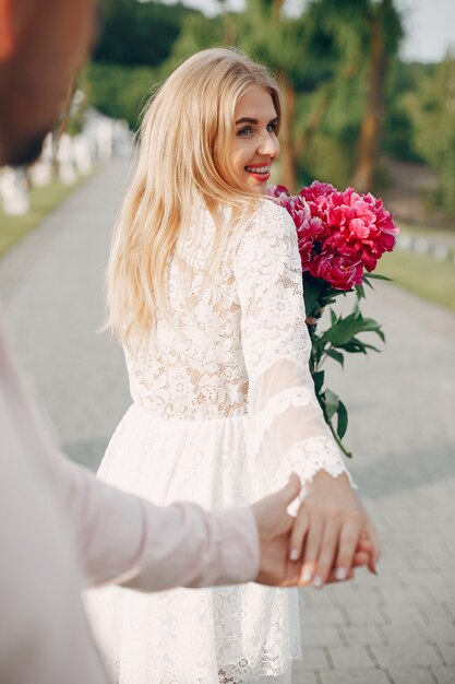 Beautiful couple spend time in a summer garden