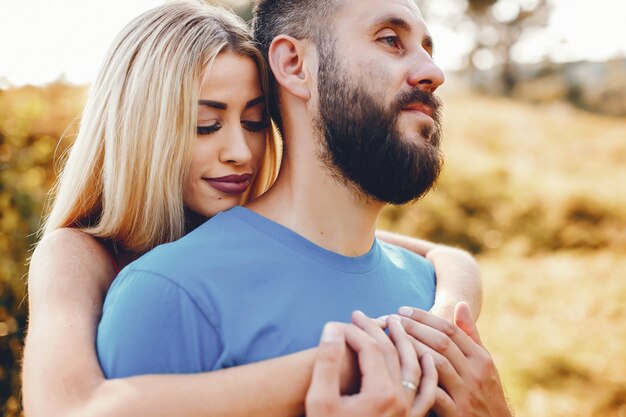 Beautiful couple spend time in a summer park