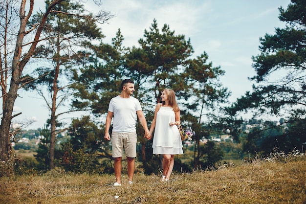 Beautiful couple spend time in a summer park