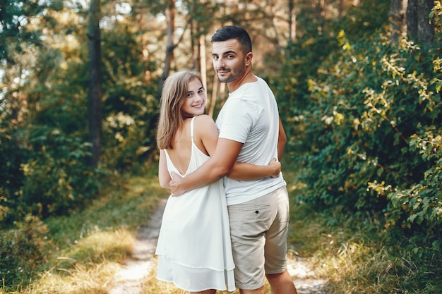 Beautiful couple spend time in a summer park