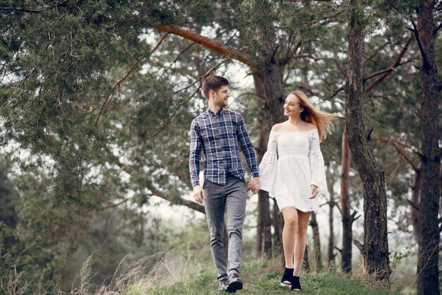 Beautiful couple spend time in a summer park