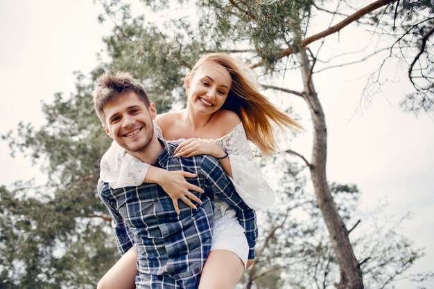 Beautiful couple spend time in a summer park