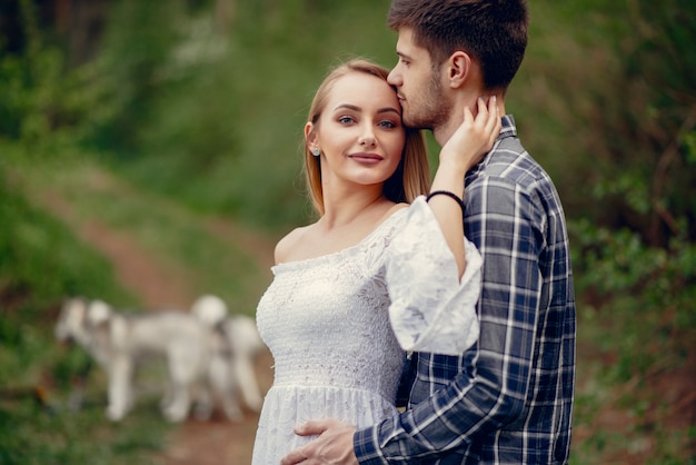 Beautiful couple spend time in a summer park