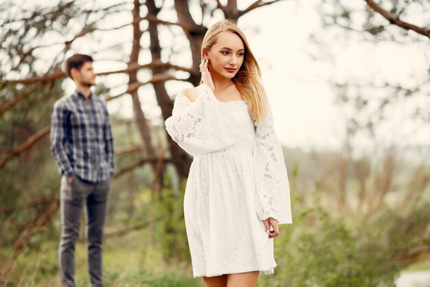 Beautiful couple spend time in a summer park