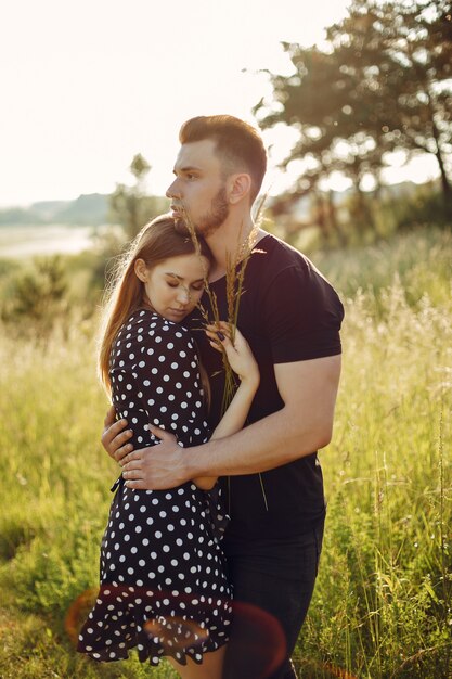 Beautiful couple spend time in a summer park