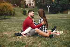 Free photo beautiful couple spend time in a summer park