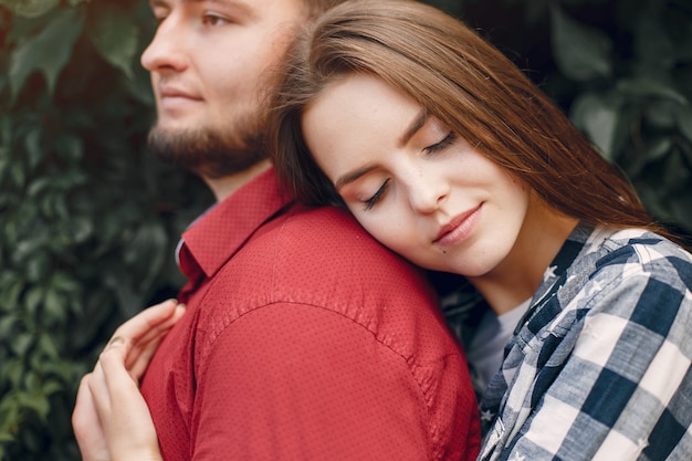 Beautiful couple spend time in a summer park