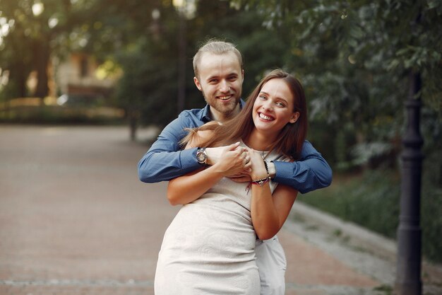 Beautiful couple spend time in a summer park