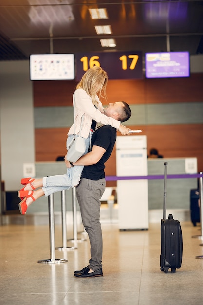 Free photo beautiful couple standing in airport