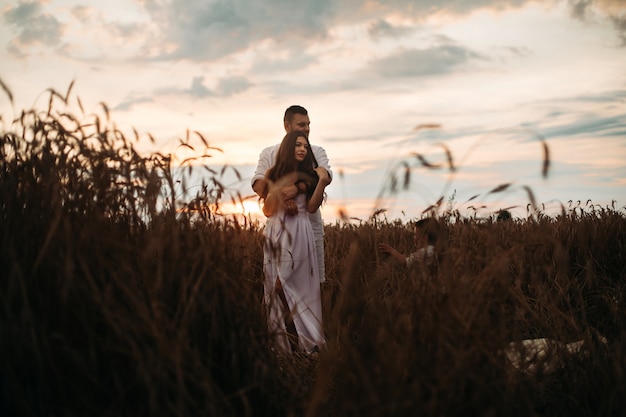 Free Photo beautiful couple standing in the field.