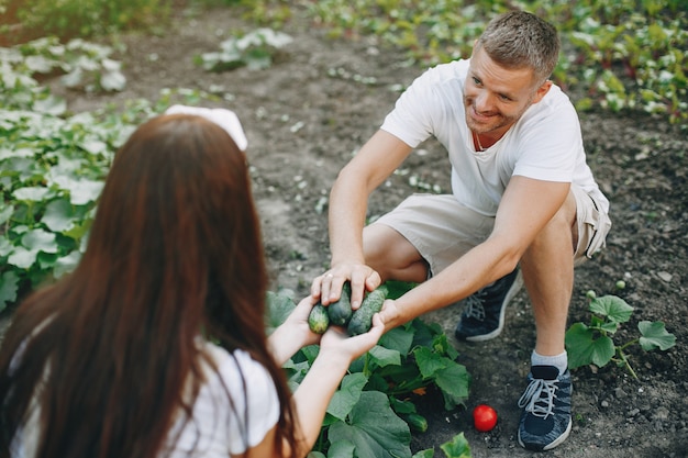 Free photo beautiful couple works in a garden