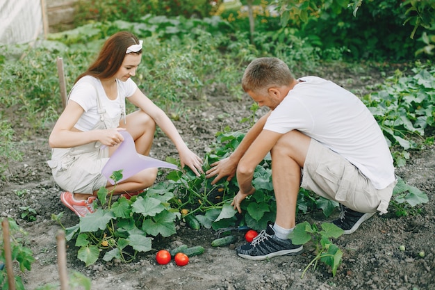 Free photo beautiful couple works in a garden