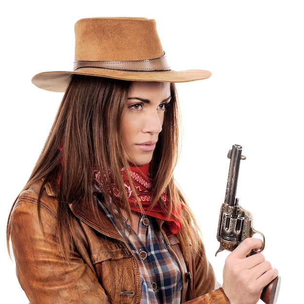 Beautiful cowgirl with gun on white background