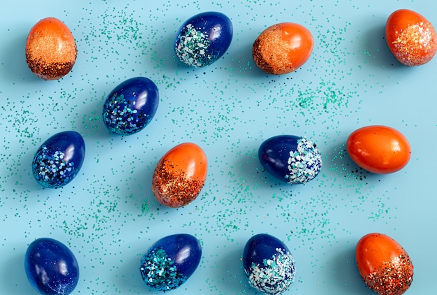 Beautiful Easter blue with blue and orange decorative eggs in spangles.