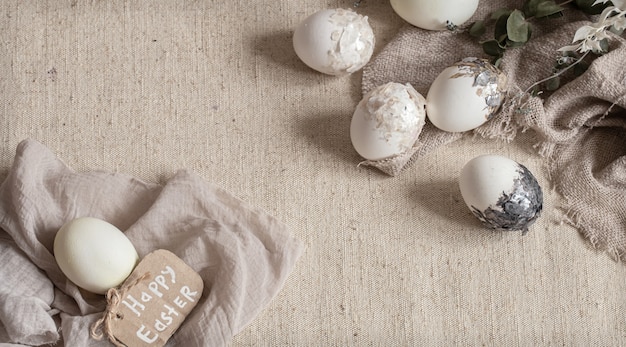 Beautiful Easter eggs scattered on the textured fabric. Easter decor concept.