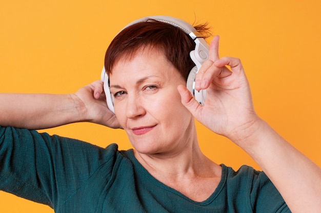 Beautiful elder female listening music