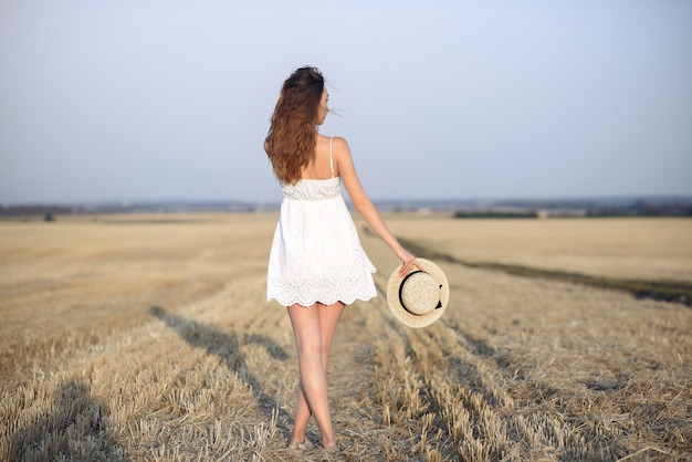 Beautiful elegant girl in a autumn wheat field