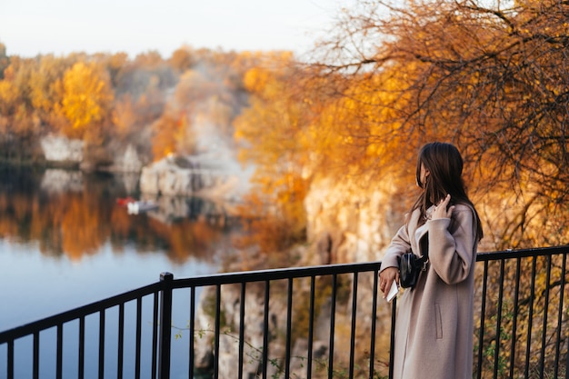 Free Photo beautiful elegant woman standing in a park in autumn